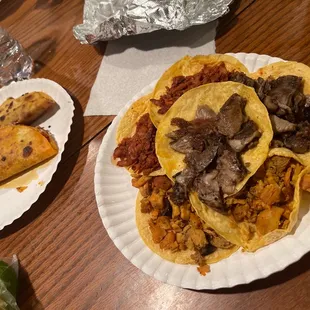 two plates of tacos and a burrito