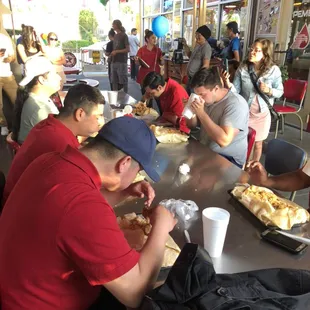 Participants trying to eat the Axle Burrito within 30 minutes..