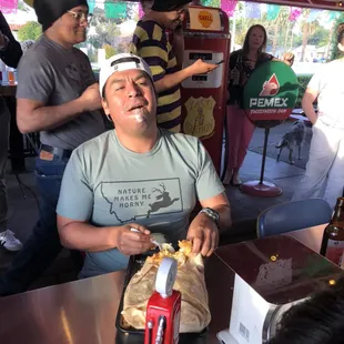 Working hard to finish his burrito goal.