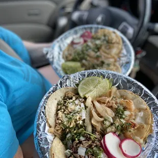 two plates of tacos on a table