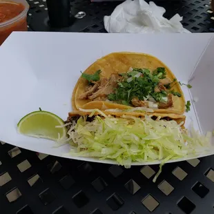 Carnitas with onion and cilantro and ground beef with cheese and lettuce