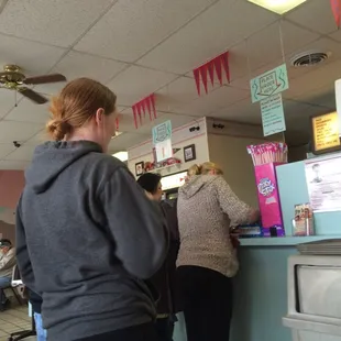 a woman ordering food at a counter
