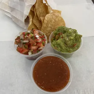 Homemade chips shown with Salsa Fresca, our hot sauce and fresh guacamole