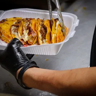 a person cutting a taco