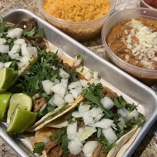 Barbacoa and carne asada tacos. Side of beans and rice!