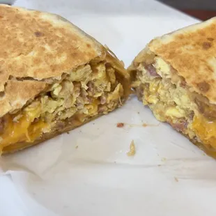 a breakfast burrito cut in half on a plate