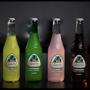 a row of bottles of different flavored beverages