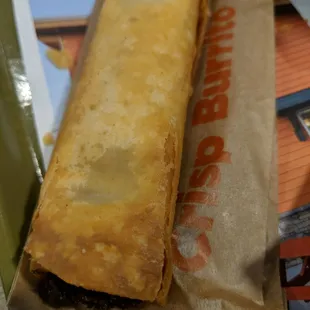 a sandwich wrapped in brown paper