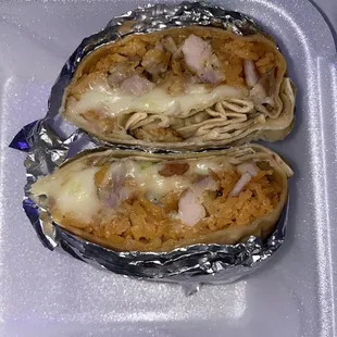 chicken burrito with rice, lettuce, and extra cheese