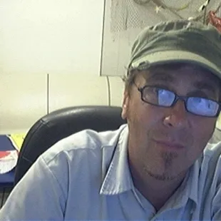 a man wearing a hat and glasses