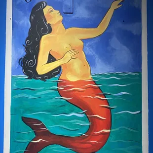 a mermaid swimming in the ocean