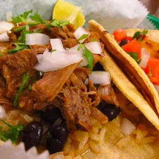 Carnitas Tacos! Corn tortilla &amp; your choice of meat, cilantro &amp; onions or pico de gallo. Served with rice &amp; beans.