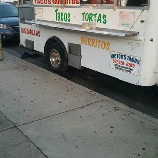 a taco truck parked on the side of the road