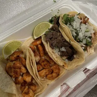 three tacos in a styrofoam container