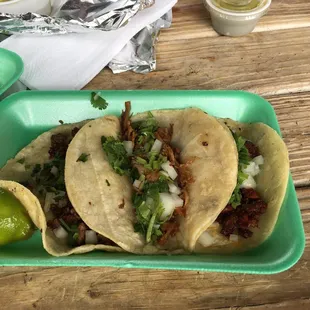 two tacos on a green plate