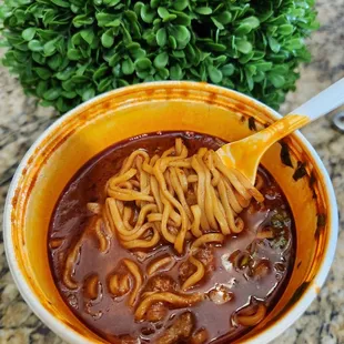 a bowl of chili and noodles