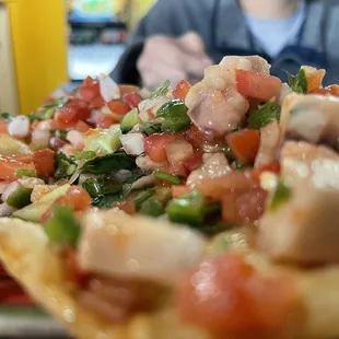 a plate of nachos and a coke