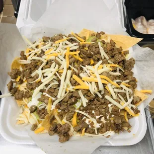 Steak super nachos served with beans,cheese,sour cream, guacamole,your choice meat and more cheese