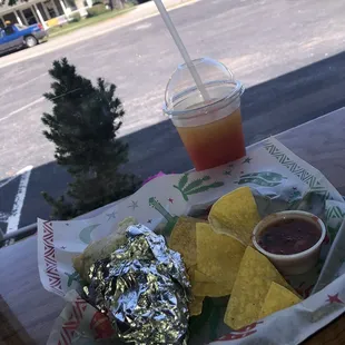 Chicken burrito and a strawberry mixed with some mango slushy.