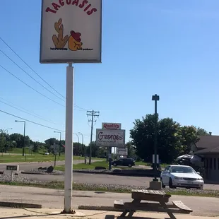 a picnic table and a sign