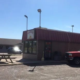 a red truck parked in front of a tacoa