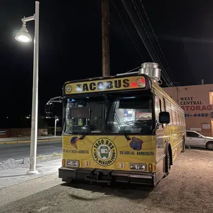 a yellow bus parked on the side of the road