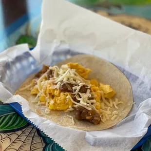 a taco with meat and cheese