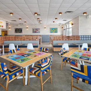a dining area with tables and chairs
