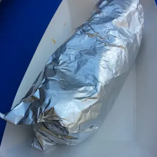 a burrito wrapped in aluminum foil