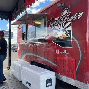 a man standing in front of a food truck