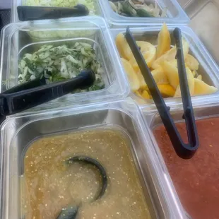 a variety of condiments in plastic containers