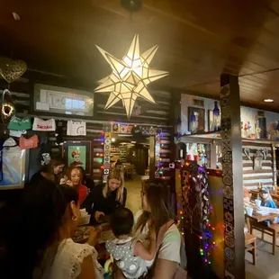 a group of people sitting at tables in a restaurant