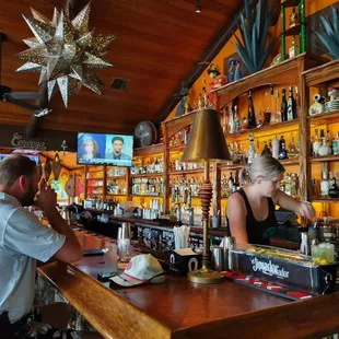 a man and a woman sitting at a bar