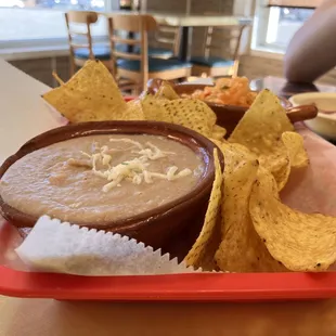a red tray with chips and dip