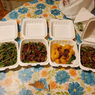 four takeout containers of food