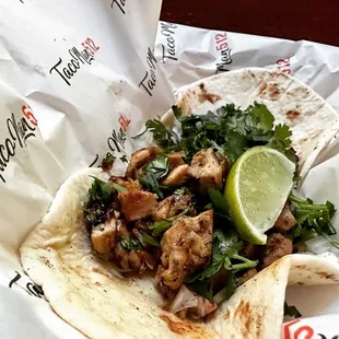 a taco with a lime wedge