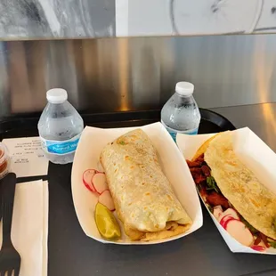 Salsas, mini complimentary waters, chicken burrito, pork quesadilla.