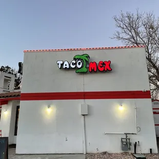 Outside - can't miss the white building with red lights