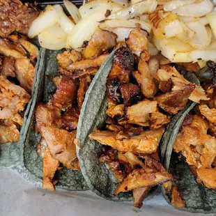 Pastor Tacos on a blue corn tortilla.