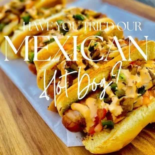 mexican hot dogs on a wooden cutting board