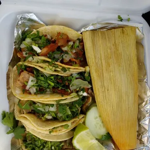 Two buche (pig stomach) tacos, two suadero (a carnitas-like fried beef from between the skin &amp; the ribs) tacos and a green chicken tamale