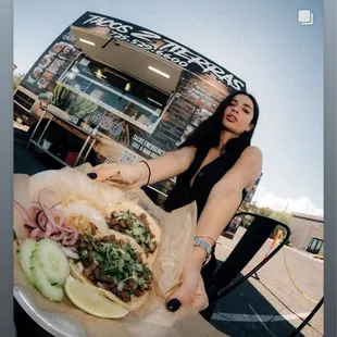 a woman holding a taco