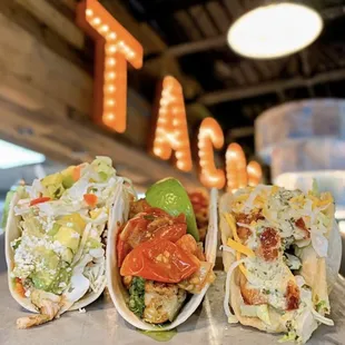 three tacoss on a table