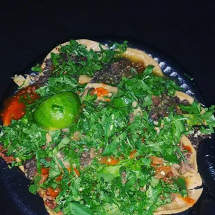 a plate of tacos on a black plate