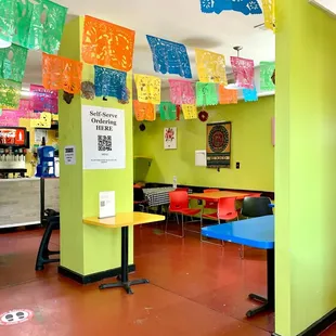 tables and chairs in a brightly colored room