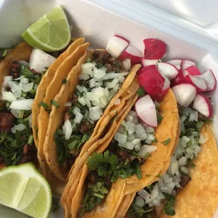 Asada (steak) tacos are great. Chorizo are good too. $2 for a taco. Comes with lines, cilantro, can get ramekins of the green and red sauce.