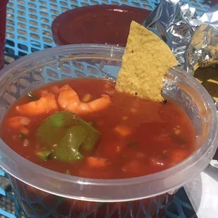a bowl of soup and a tortilla