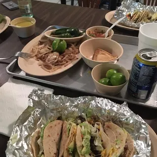 a tray of tacos and a can of soda