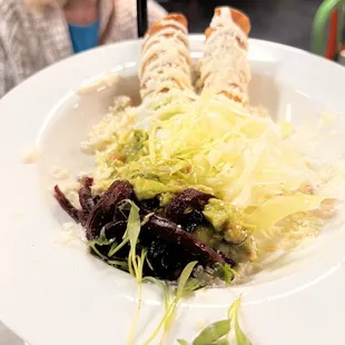  a plate of tacos and salad