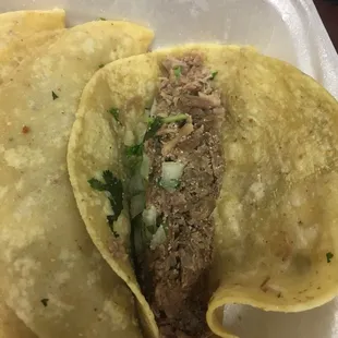 two tacos in a styrofoam container